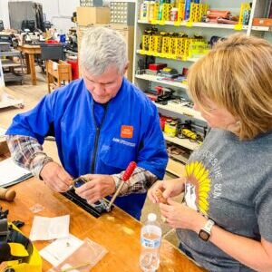 Two people work on a woodworking project at The Rivet in State College.